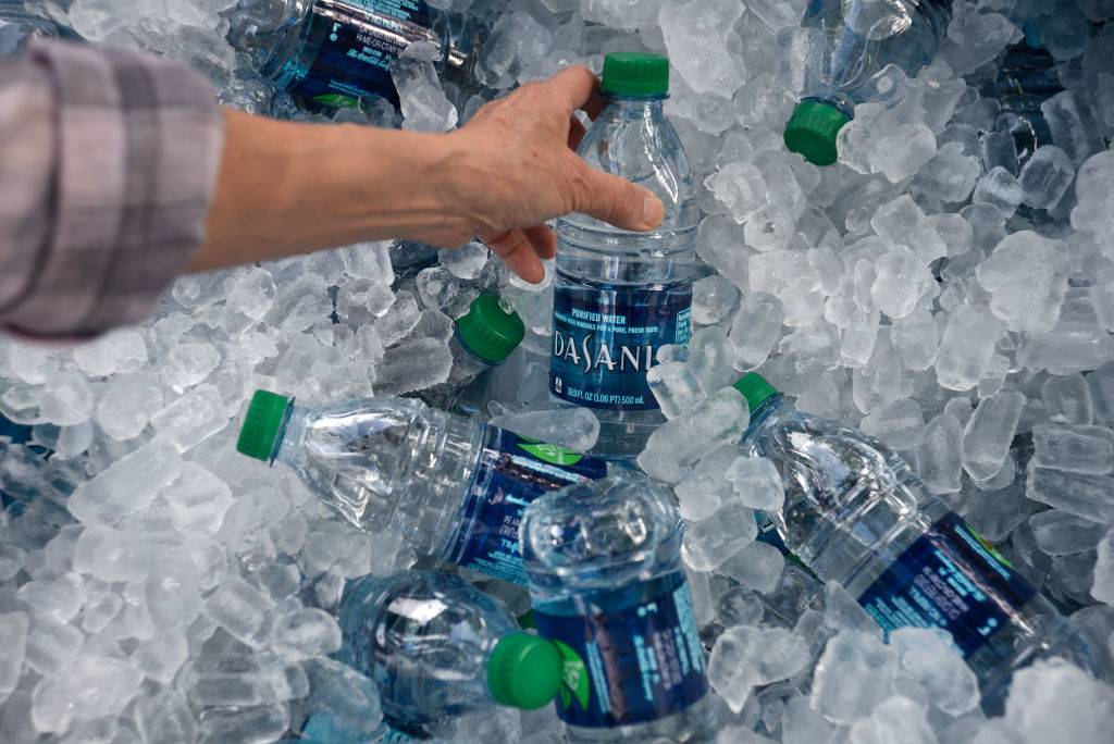 A tub filled with ice and plastic bottles of Dasani purified bottled water