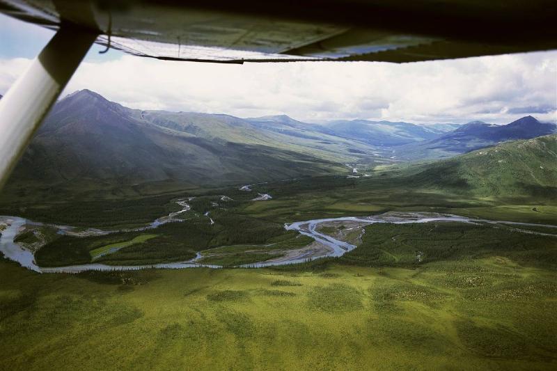 A view from a helicopter shows a remote river in Alaska.