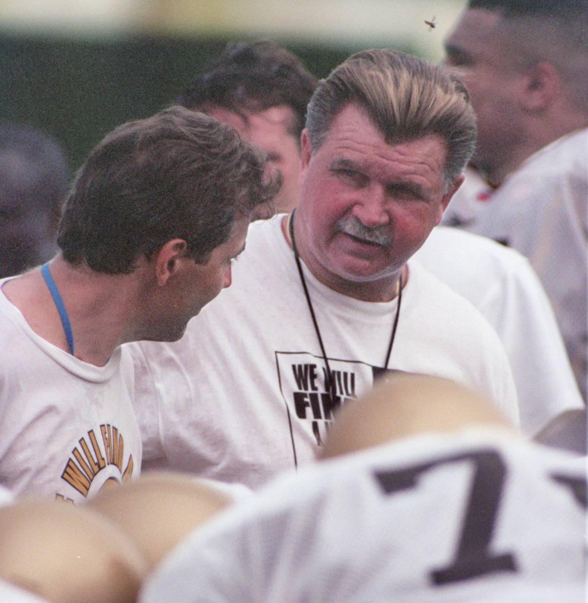 New Orleans Saints coach Mike Ditka talks with one of his coaches during football practice at the University of Wisconsin campus in LaCrosse,WI.