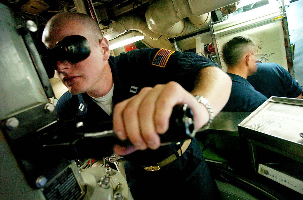 soldier looking through a parascope on a submarine