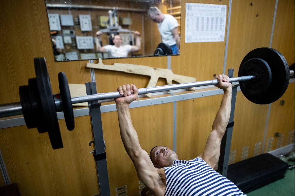crew members working out at a gym on a submarine