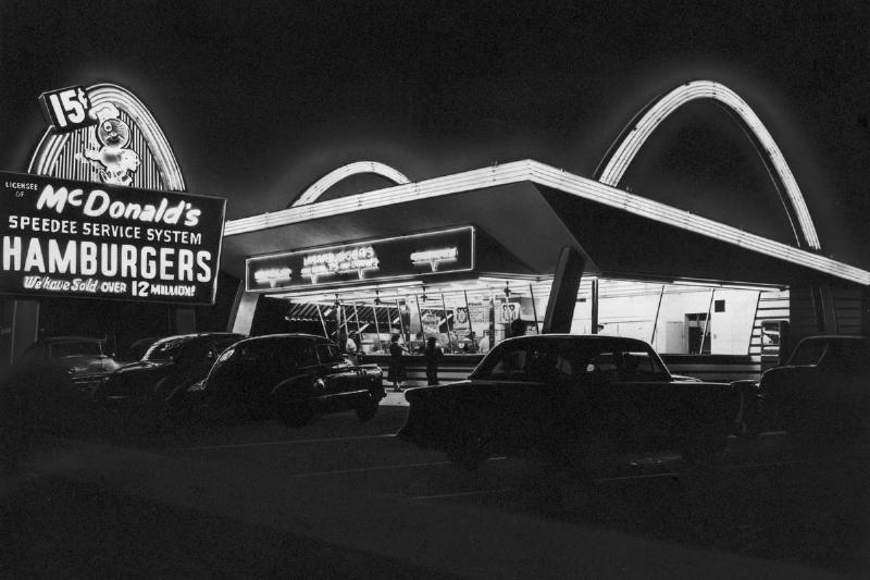The first McDonald's location in Illinois, lit up at night in 1955.