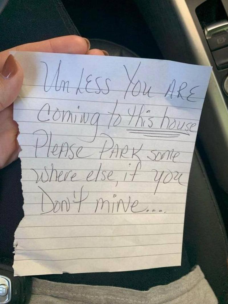 Handwritten note asking not to park in front of their house. 