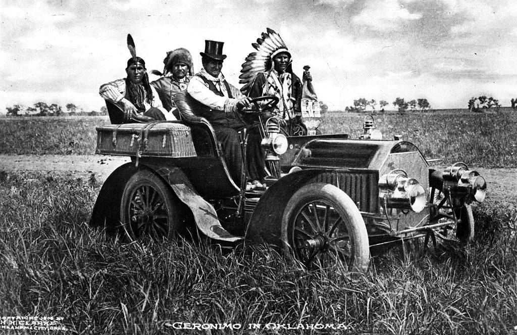 Top-hatted Chiricahua Apache chief Geronimo driving a motor car in Oklahoma