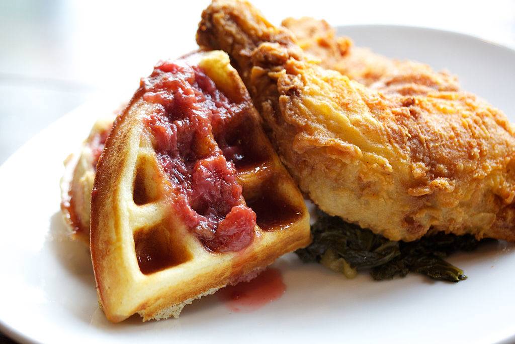 chicken and waffles with some strawberry jam