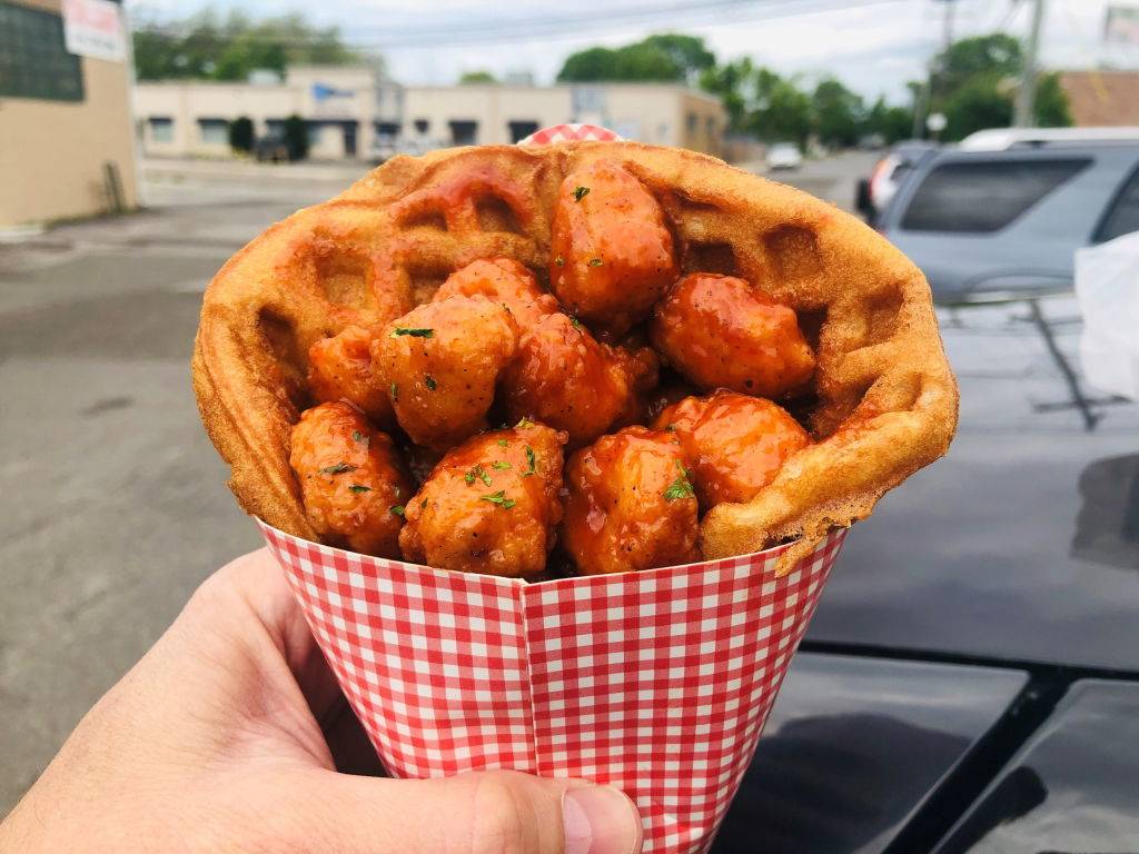 Popcorn chicken with barbecue sauce in a waffle cone