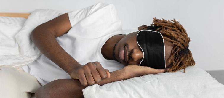 Man sleeping wearing eye mask 