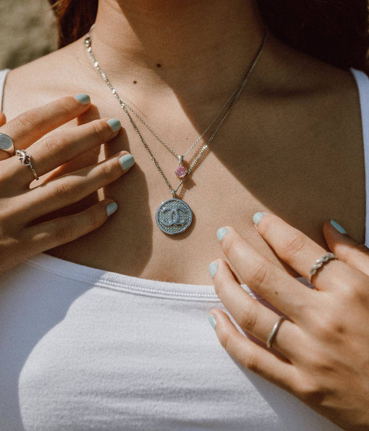 Stacked necklaces and rings on woman