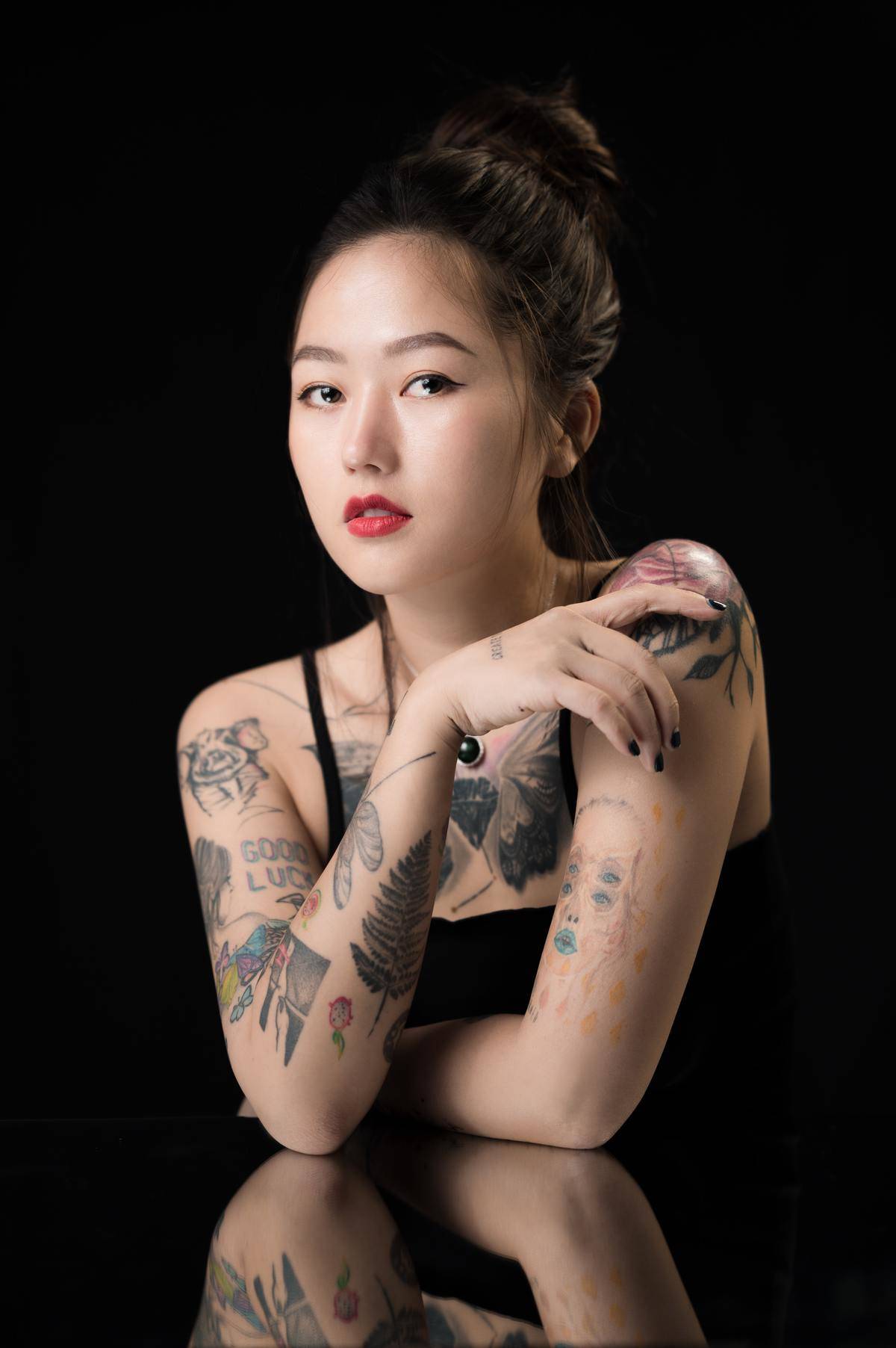 Woman's arms with different tattoos 
