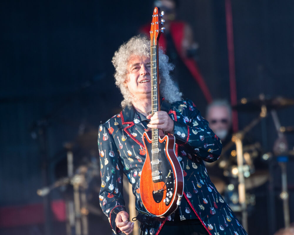 Brian May holds electric guitar