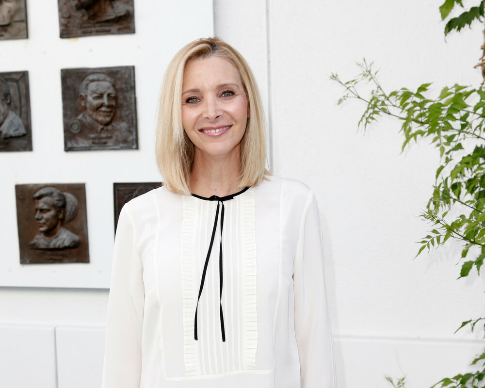Lisa Kudrow wears white blouse and smiles for photo 