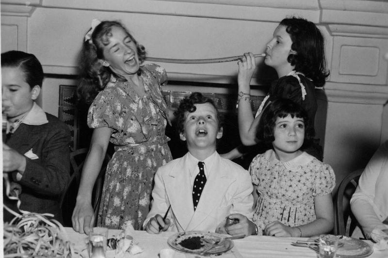 circa 1931: Child actors at a tea party; from left to right, standing, Bonita Granville, Judy Garland, and sitting, Tommy Kelley and Sybil Jason. 