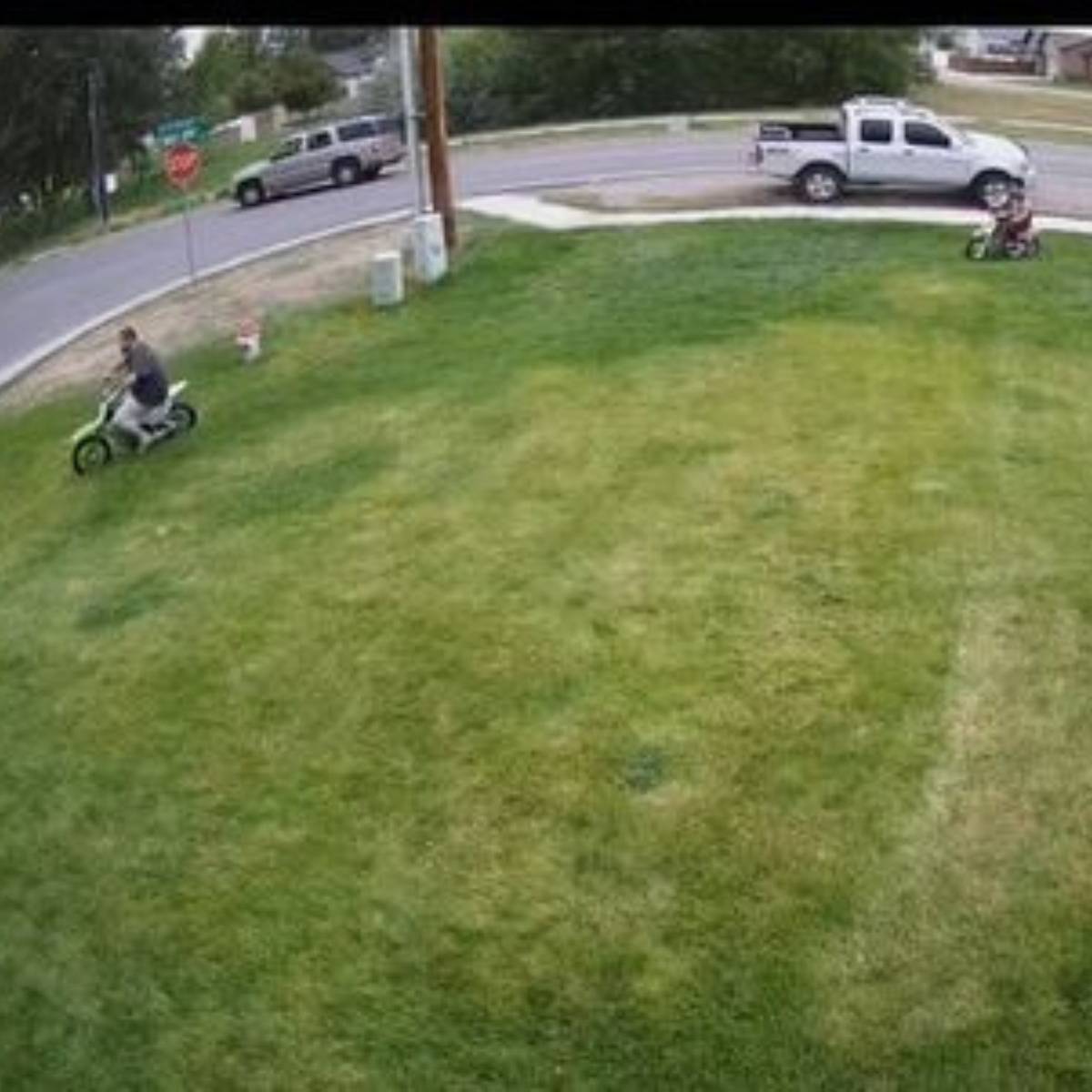people dirt biking across a lawn