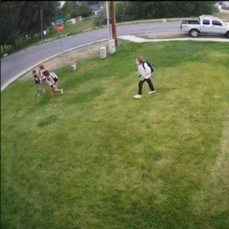 kids cutting across lawn