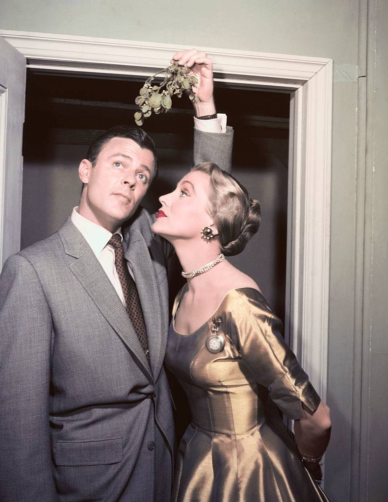 Robert Sterling solicits a little Yuletide attention from his wife Anne Jeffreys with a sprig of Mistletoe