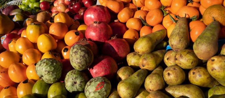 Fresh raw mixed fruits displayed on stand