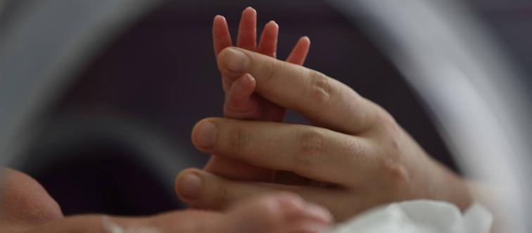 Baby's hand held in Neonatal Department