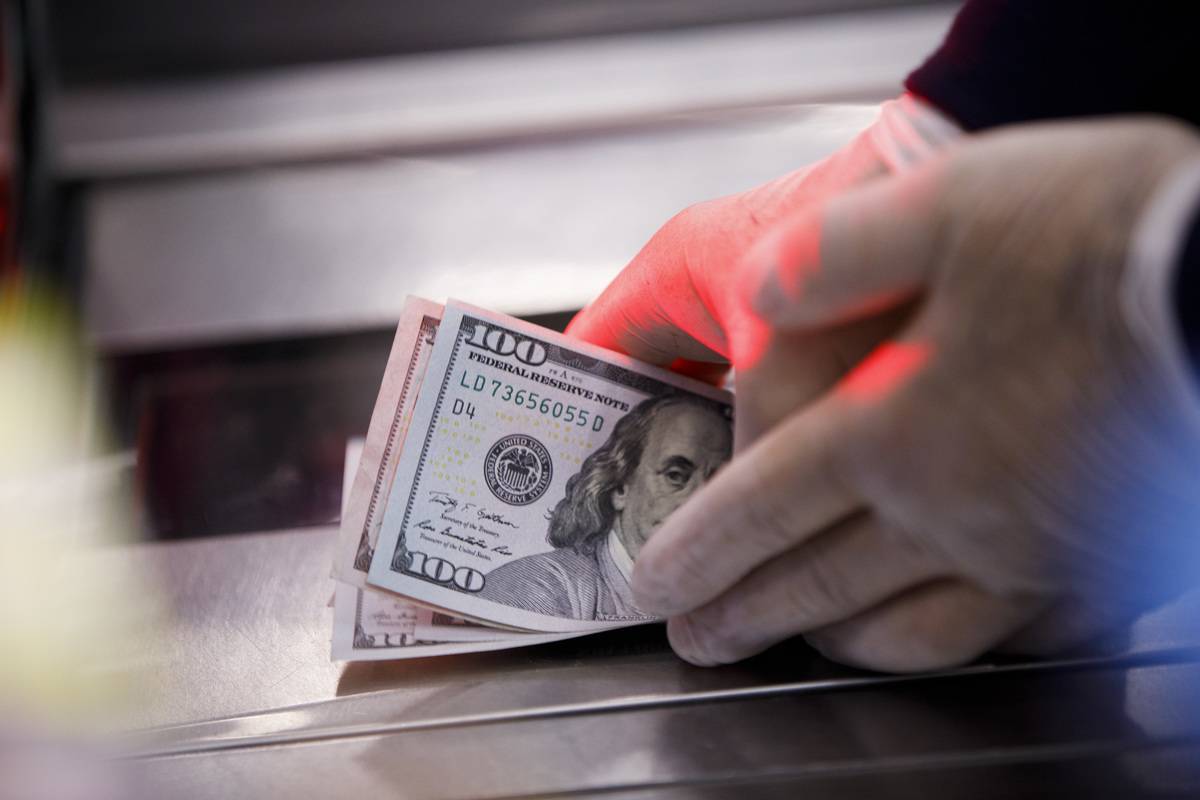 An employee counts cash at a Wal-Mart Stores Inc. location in Burbank, California, U.S