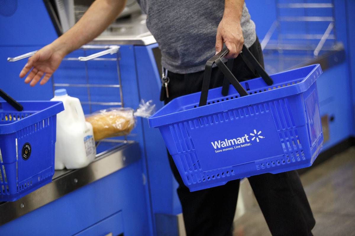 A customer uses a self-checkout kiosk at a Wal-Mart Stores Inc. location in Burbank, California, U.S.
