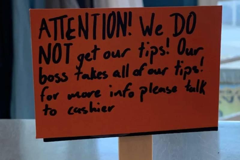 Sign: Attention! We do not get our tips! Our boss takes all of our tips! For more info please talk to cashier