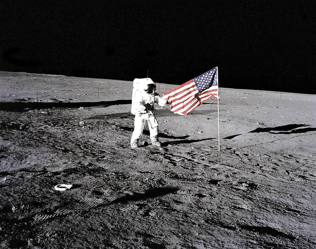 astronaut with american flag on the moon