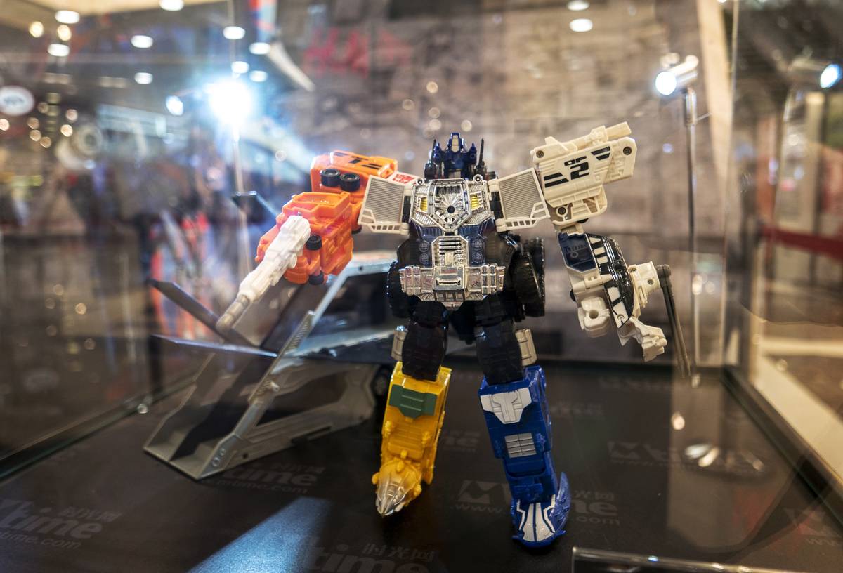 Optimus Prime's toys of various versions exhibited in a...