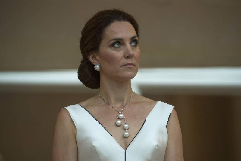 WARSAW, POLAND - JULY 17: Catherine, Duchess of Cambridge listens as Prince William, Duke of Cambridge gives a speech during the Queen's Birthday Garden Party at the Orangery on day 1 of their official visit to Poland on July 17, 2017 in Warsaw, Poland.