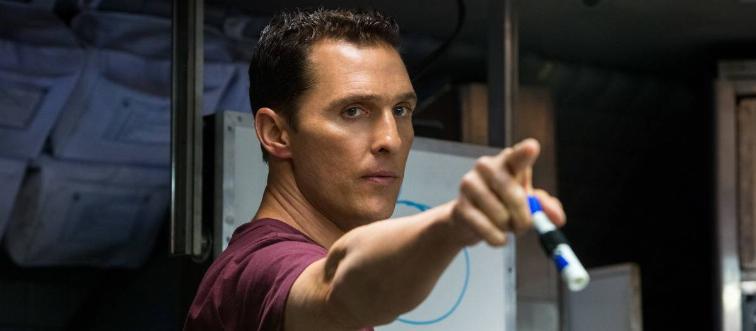 Matthew McConaughey pointing with dry erase marker in his hand in front of drawn circle in Insterstellar