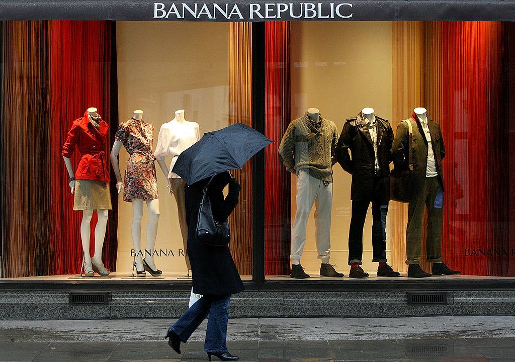 Members of the public pass the Banana Republic store on a rainy day