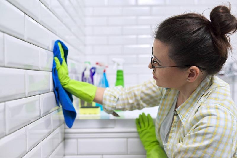 female-polishing-tiled-wall-in-bathroom-with-micro-2022-01-13-23-59-14-utc
