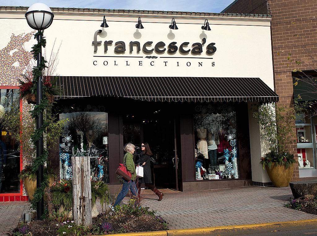 Shoppers pass in front of a Francesca's Collections store