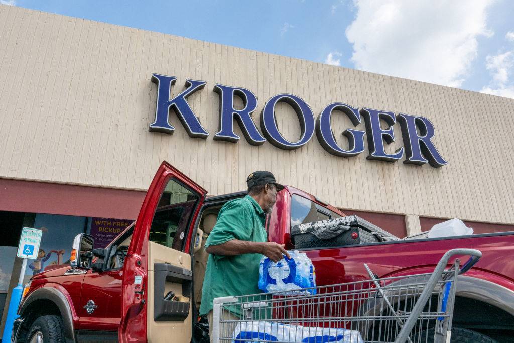 A customer loads his truck after shopping at a Kroger grocery store