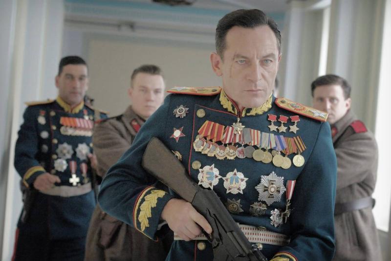 Jason Isaacs holding Kalashnikov rifle as Field Marshall Zhukov in The Death of Stalin