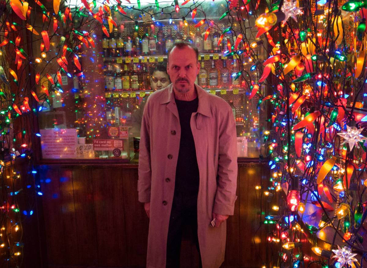 Michael Keaton standing among colored lights as Riggan Thomson in Birdman