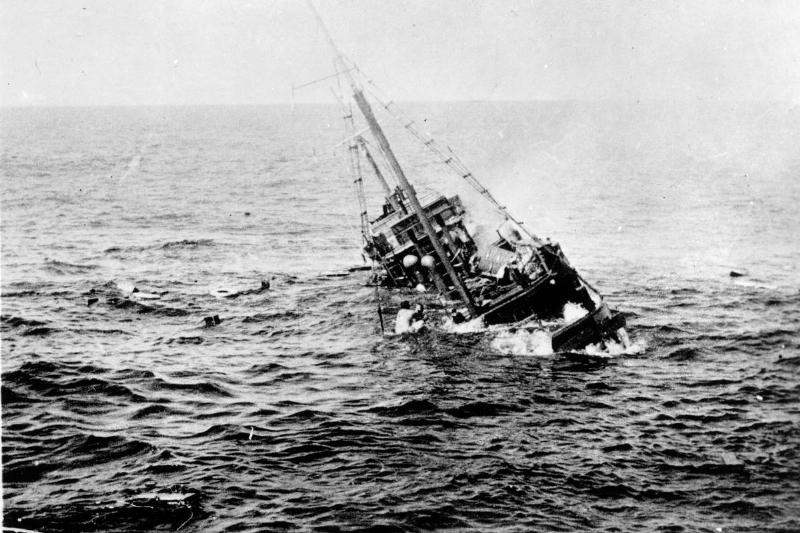 View of the aftermath of the sinking of a Japanese merchant ship by the  US Navy submarine USS Tambor, with survivors visible on the ship's 
rigging, 1944.