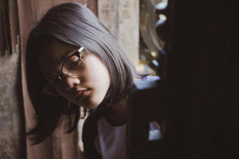 girl in glasses looking through closet