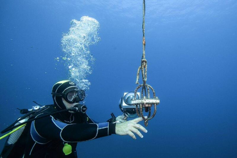 French diver Eric Blin, a water environment and coastline waste-management and biodiversity expert who is taking part in the 'sea@dvanced sound' project, checks a hydrophone off the coast of the Ajaccio, the capital of the French Mediterranean island Corsica on September 11, 2019.