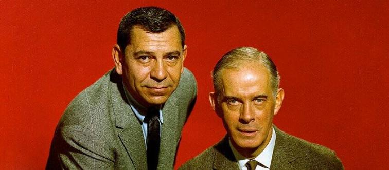 two men in front of a red background