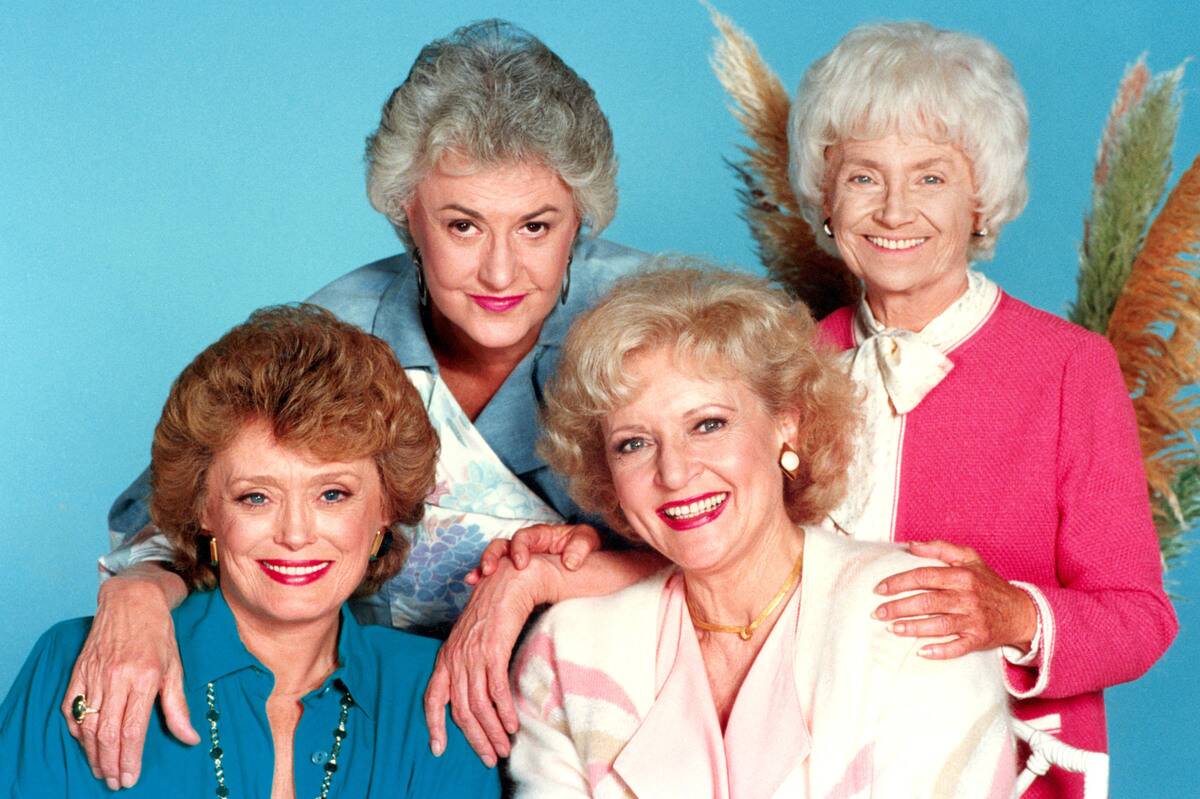 four older women in front of a blue background