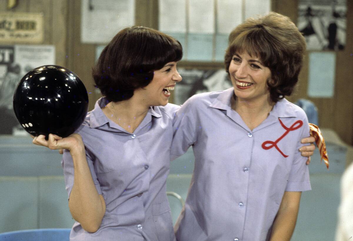 two women at a bowling alley