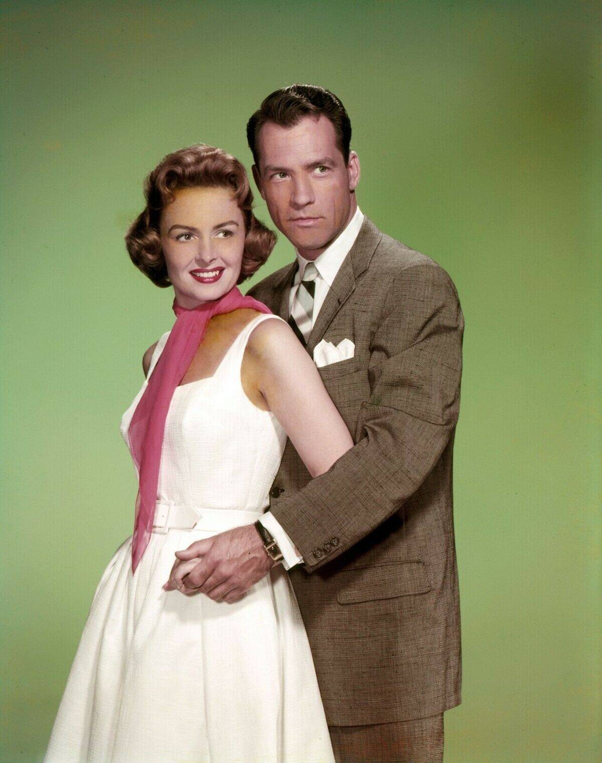 man and woman in front of a green background