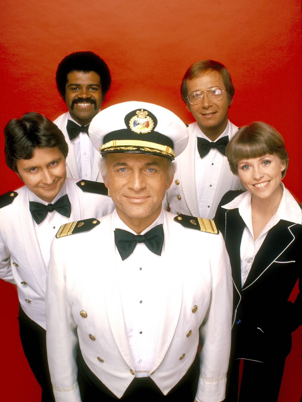 people in uniform in front of a red background