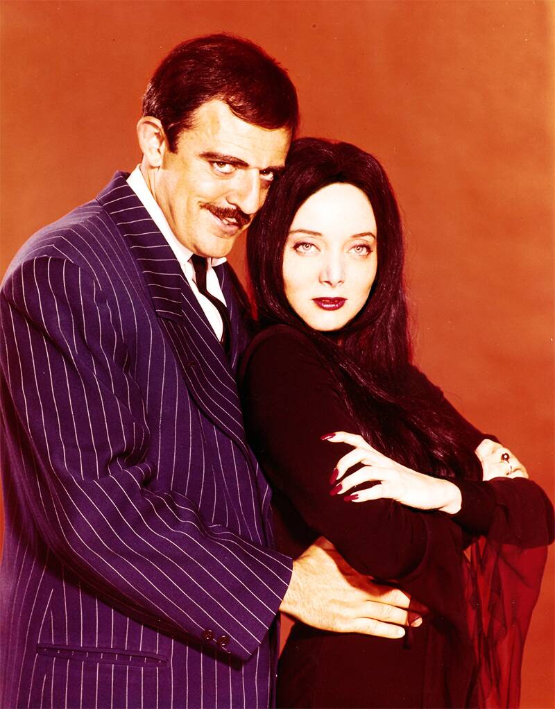 man and woman in front of an orange background