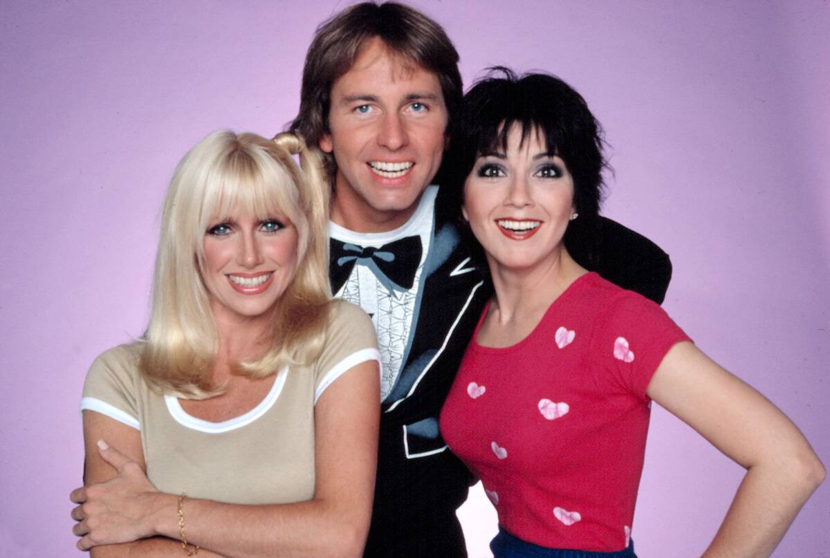 two women and a man in front of a purple background