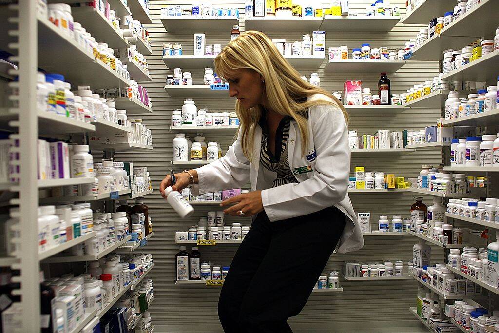 pharmacist getting a pill bottle