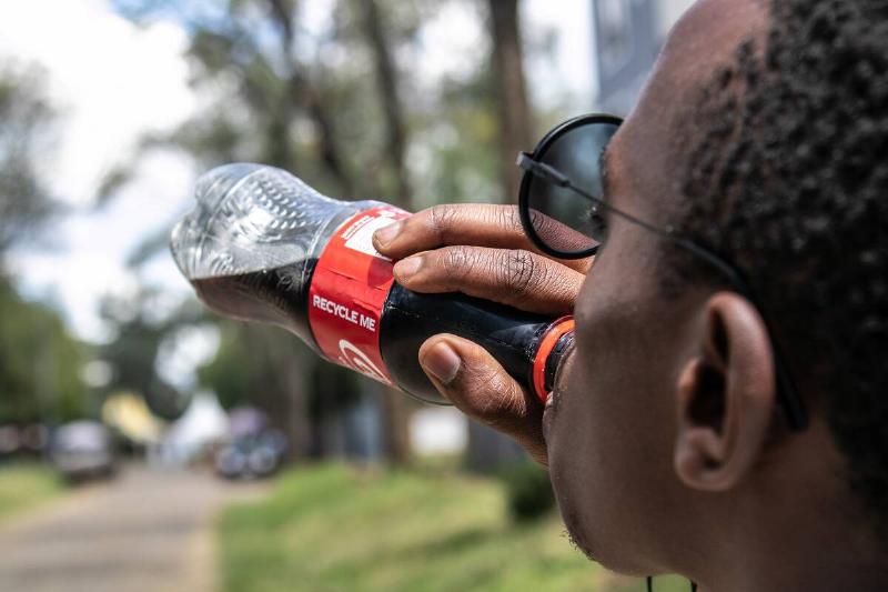 In this photo illustration a man seen drinking Coca-cola. An...
