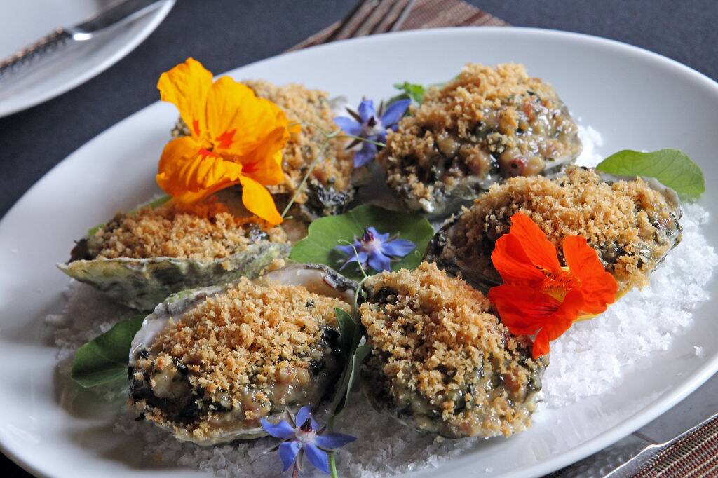 oysters rockefeller on a plate with colorful flowers