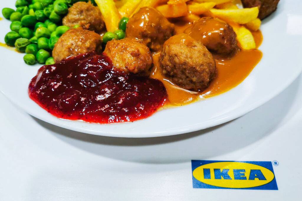 Ikea classic meal with Swedish meatballs, French fries, green peas and lingonberry sauce