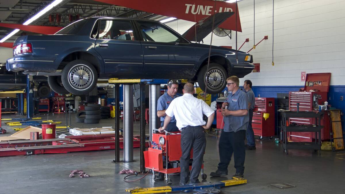 Motor car on hydraulic lift repair workshop Springfield Missouri USA