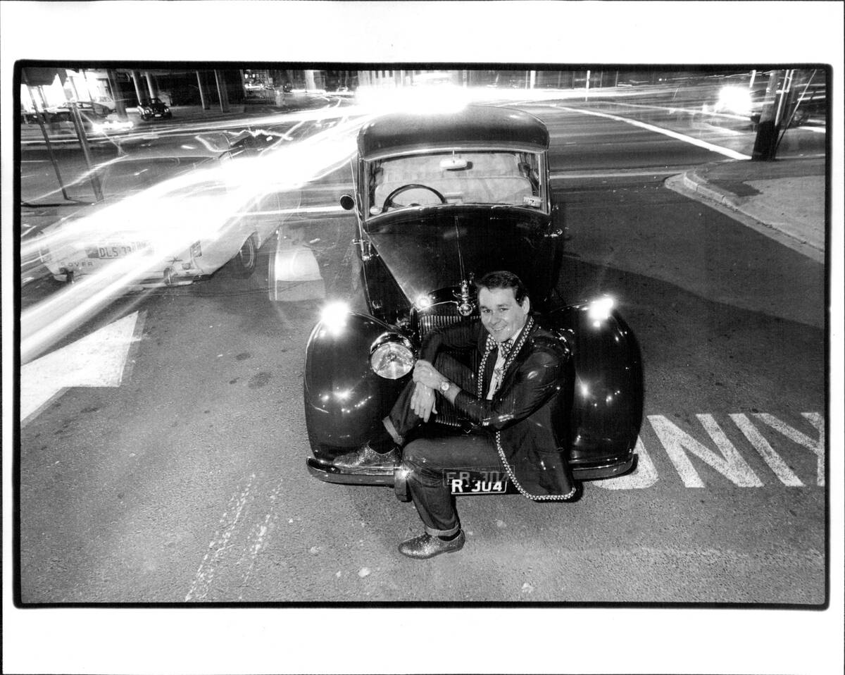 Denis Watkins, producer of lavish musical spectaculars of gross bad taste. He is, among other things, the proud owner of a 1949 triumph renown limousine.